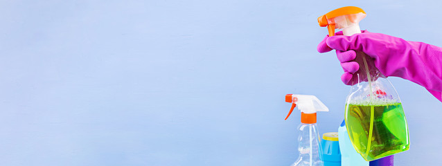 Cleaning service concept. Colorful cleaning set for different surfaces in kitchen, bathroom and other rooms. Banner.