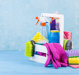 Cleaning service concept. Colorful cleaning set for different surfaces in kitchen, bathroom and other rooms.
