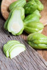Fresh chayote fruits (Sechium edulis) on wood background