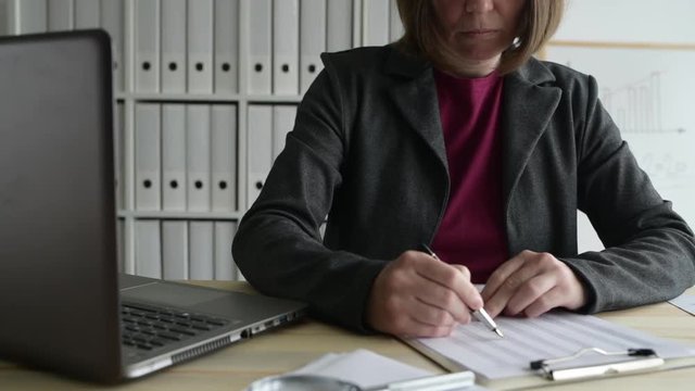 Businesswoman Analyzing Business Data Spreadsheet In Office, Dolly Slider Shot