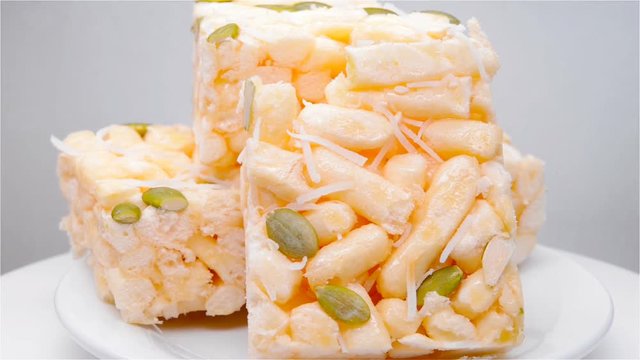Caramel treats with shredded coconut and melon seeds rotating