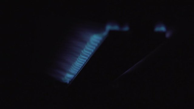 A Gas Grill Being Ignited, Left On For A Few Seconds And Then Turned Off. The Flame Is Blue.