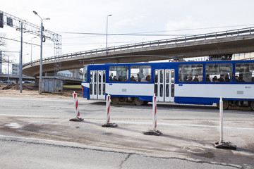 City street with transport and buildings. View from the street. Tram and cars, city life. Travel photo 2019.