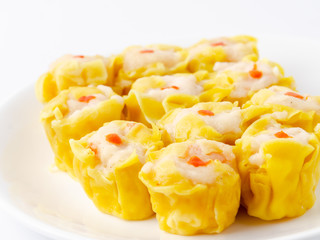Chinese steamed shrimp dumplings on white dish