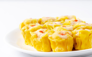 Chinese steamed shrimp dumplings on white dish