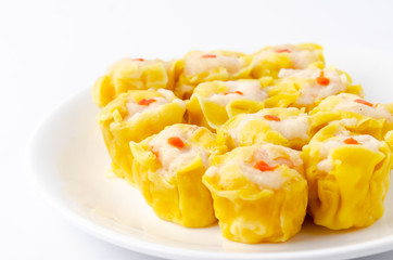 Chinese steamed shrimp dumplings on white dish