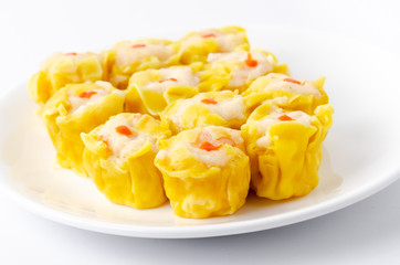 Chinese steamed shrimp dumplings on white dish