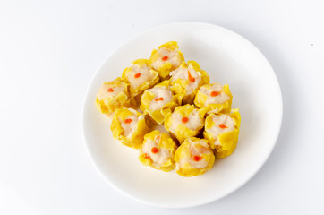 Chinese steamed shrimp dumplings on white dish