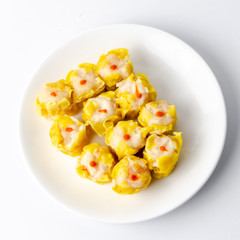 Chinese steamed shrimp dumplings on white dish