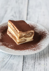 Portion of tiramisu on the white plate