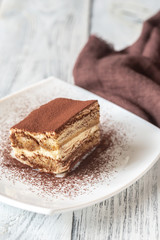 Portion of tiramisu on the white plate