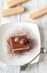 Portion of tiramisu on the white plate