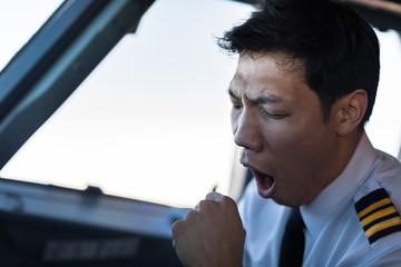 Exhausted male pilot in the cockpit airplane, flying. © globalmoments