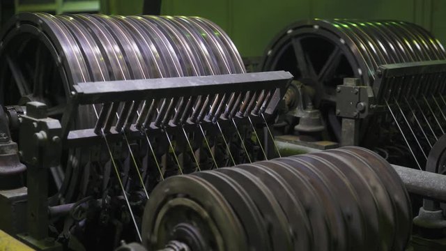 Metalworking and steel production, the process of winding and electroplating, brass wire on reels, rotating spools metal cord.