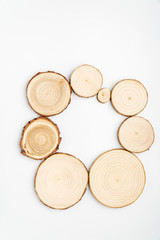 Pine tree cross-sections with annual rings on white background. Lumber piece close-up shot, top view.