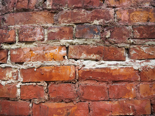Brick wall with unevenly laid bricks