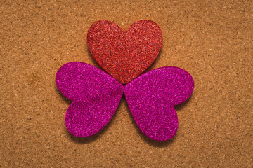 Fototapeta premium top view of three heart shapes over a brown background