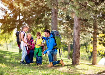 Family group hiking in woods.