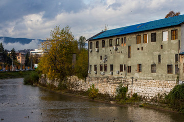 Fototapeta na wymiar Old and abandoned buildings on the banks of the Miljacka River in Sarajevo. Bosnia and Herzegovina