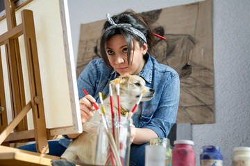 Beautiful woman painting with her dog © Daniel