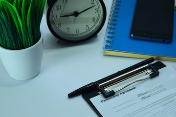 Partnership Agreement Planning on Background of Working Table with Office Supplies. Business and Schedule Concept Planning on White Desk