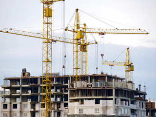 Fototapeta na wymiar Construction site background. Hoisting cranes and new multi-storey buildings. I.ndustrial background.