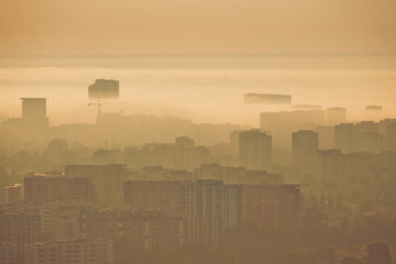 Warsaw smog and foggy city block of flates with sunrise beautiful colors