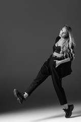 Young beautiful female dancer is posing in the studio
