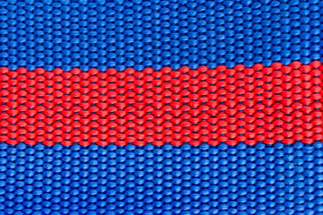 blue and red woven harness close up as background and texture