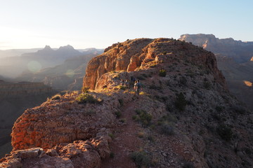 Hikers enjoy the sunset on the northewestern tip of Horseshoe Mesa in Grand Canyon National Park, Arizona.