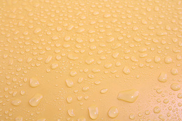 Water drops on a yellow background.