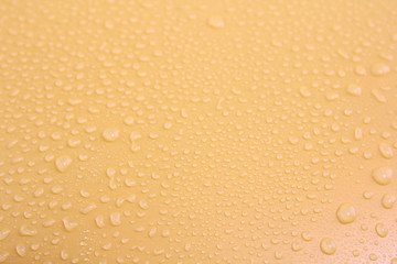Water drops on a yellow background.