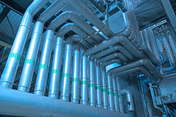 Equipment, cables and piping as found inside of a modern industrial power plant