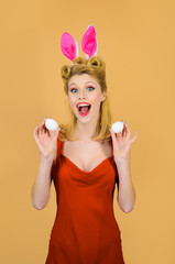 Happy Easter! Easter day. Spring holiday. Smiling girl with bunny ears holds white egg. Egg hunt. Easter bunny. Easter concept. White eggs. Bunny girl. Spring sales.