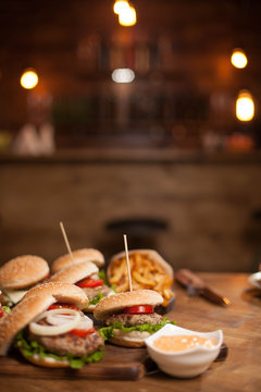 Food composition of bugers variety on a wooden table