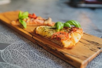 Pizza pieces upcut on a cutting board