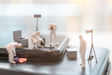 Miniature people : Police And Detective are working on smartphone , Crime scene investigation ,...