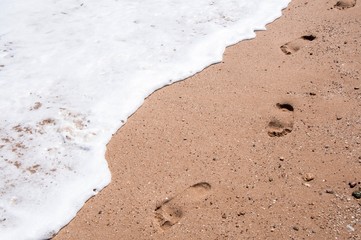 Footprints standing bare in the sand