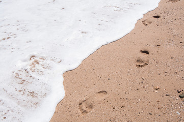 Footprints standing bare in the sand