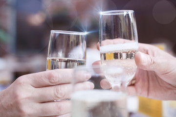 Two hands with glasses of sparklin wine