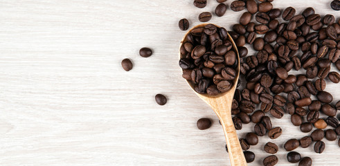 wooden spoon and roasted coffee beans close up