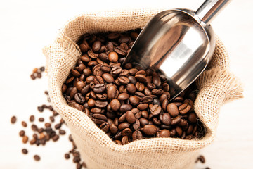 metal scoop in the bag with roasted coffee beans close up