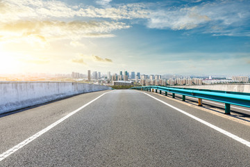 Naklejka premium Asphalt highway passing through the city above in Shanghai at sunset