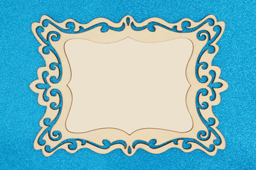Wood picture frame on a blue glitter background