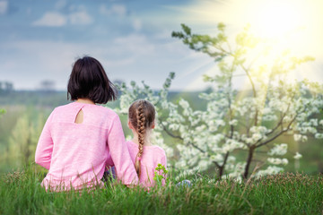 Mother and daughter enjoying nature in sunny summer day.