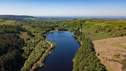 cod beck reservoir in north yorksire showing the blue waters and trees around the lake