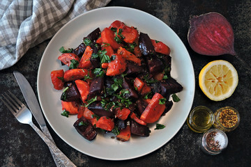 Healthy warm salad with baked beets, pumpkin and carrots. Vegan salad of warm vegetables.