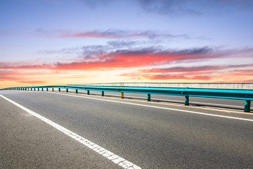 Asphalt highway ground and beautiful clouds at sunrise