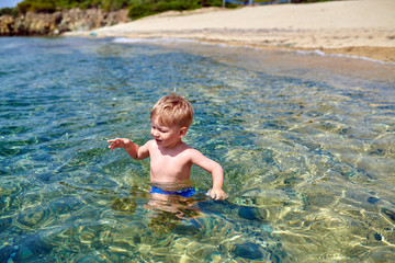 Toddler boy on beach