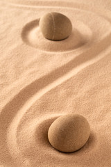Fototapeta na wymiar zen meditation stone in raked sand.